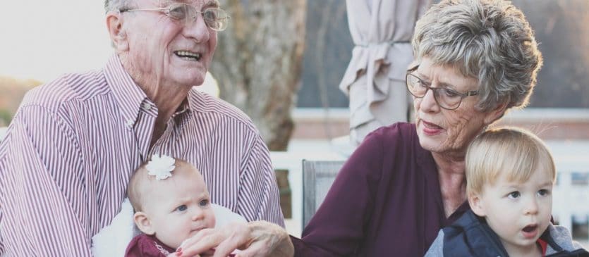 seniors holding grandchildren