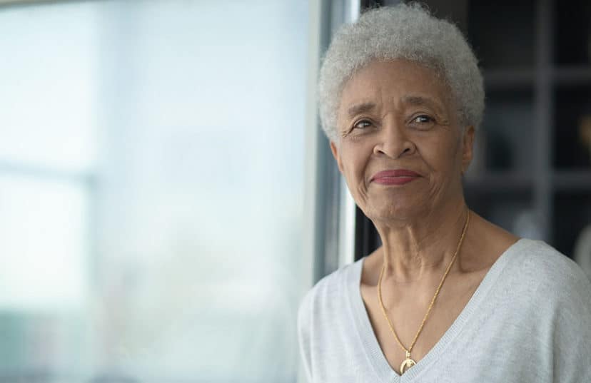 A Senior Woman Smiling As She Reflects stock photo
