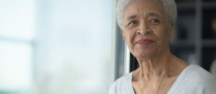 A Senior Woman Smiling As She Reflects stock photo